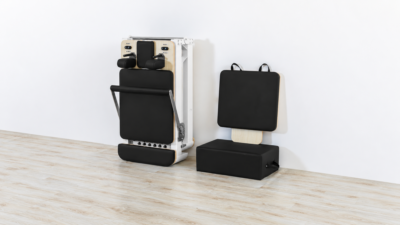 Contour Pro Folding Aluminium black reformer folded upright beside its jump board and Pilates box